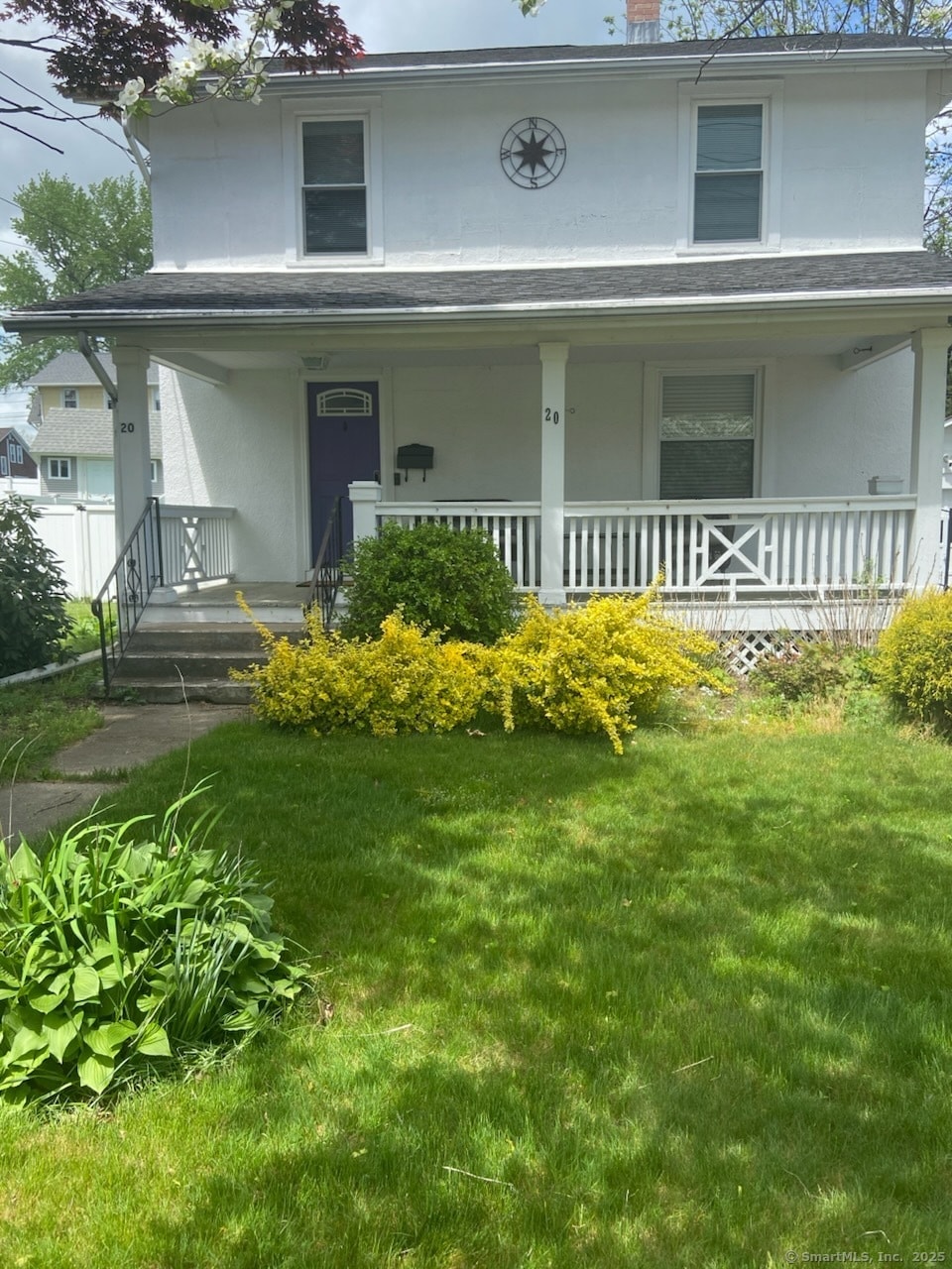 20 Manross Rd, Bristol, CT 06010 - view of front of home featuring covered porch, stucco siding, a front lawn, and a chimney