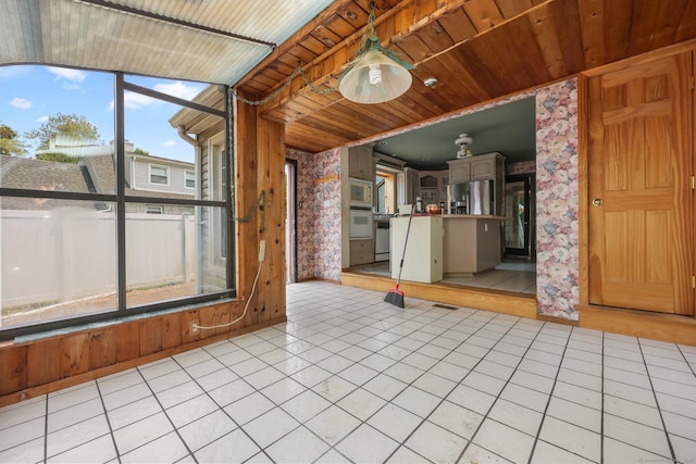 283 Derby Ave, Orange, CT 06477 - unfurnished living room with wallpapered walls, wood ceiling, and light tile patterned flooring