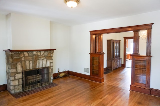 47 Mountford St, Hartford, CT 06114 - unfurnished living room with wood finished floors and a stone fireplace