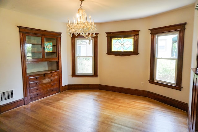 47 Mountford St, Hartford, CT 06114 - spare room with light wood-style flooring and a chandelier