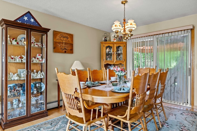 2 Marion Ln, Canterbury, CT 06331 - dining room with a chandelier, wood finished floors, baseboard heating, and a textured ceiling