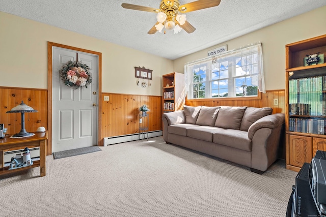 2 Marion Ln, Canterbury, CT 06331 - living room featuring a wainscoted wall, wooden walls, baseboard heating, a textured ceiling, and carpet flooring
