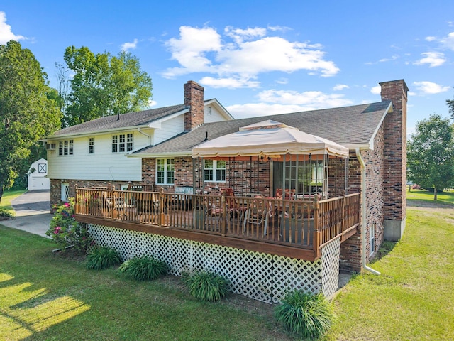 2 Marion Ln, Canterbury, CT 06331 - back of property with a chimney, a yard, a wooden deck, and a shingled roof