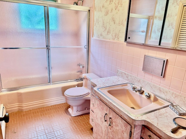56 Clapboard Ridge Rd, Danbury, CT 06811 - bathroom with toilet, enclosed tub / shower combo, brick patterned flooring, vanity, and tile walls