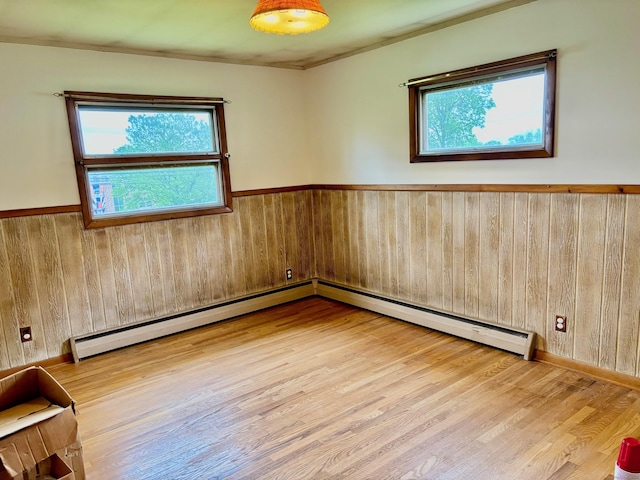 56 Clapboard Ridge Rd, Danbury, CT 06811 - unfurnished room with healthy amount of natural light, a wainscoted wall, wooden walls, and wood finished floors