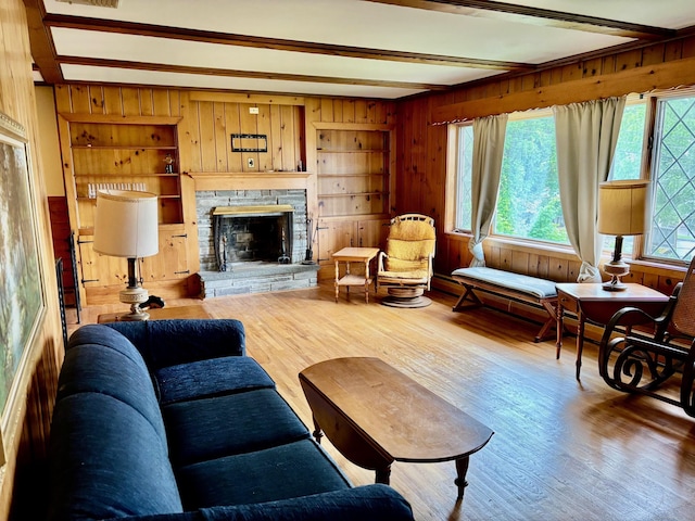 56 Clapboard Ridge Rd, Danbury, CT 06811 - living room with beam ceiling, wooden walls, wood finished floors, and a stone fireplace