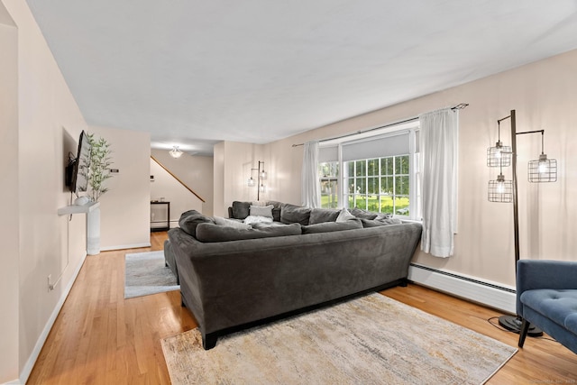 183 Brentmoor Rd, East Hartford, CT 06118 - living room featuring a baseboard heating unit and light wood-style floors