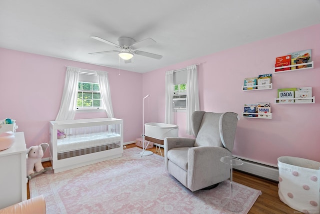 183 Brentmoor Rd, East Hartford, CT 06118 - living area with a baseboard heating unit, a ceiling fan, and wood finished floors