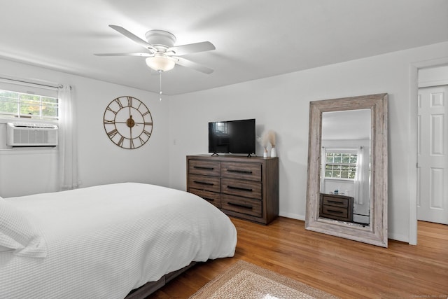 183 Brentmoor Rd, East Hartford, CT 06118 - bedroom with cooling unit, multiple windows, wood finished floors, and a ceiling fan