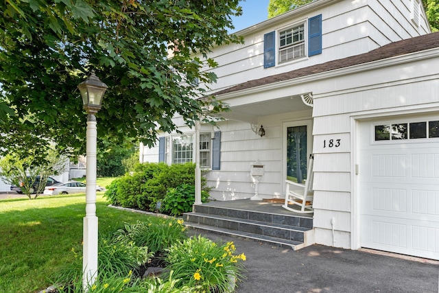 183 Brentmoor Rd, East Hartford, CT 06118 - property entrance with a garage and a yard