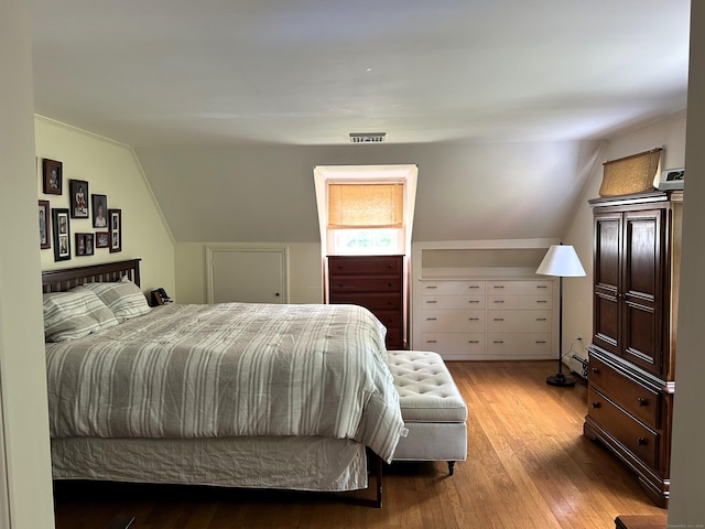 19 Orchard Ln, New Canaan, CT 06840 - bedroom featuring wood finished floors, vaulted ceiling, and a baseboard heating unit