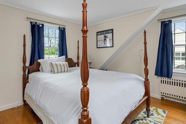 19 Orchard Ln, New Canaan, CT 06840 - bedroom featuring radiator heating unit, multiple windows, wood finished floors, and crown molding