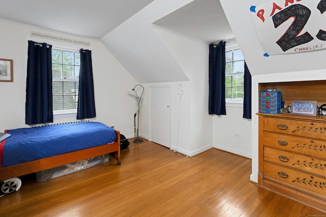 19 Orchard Ln, New Canaan, CT 06840 - bedroom with light wood finished floors, multiple windows, vaulted ceiling, and crown molding