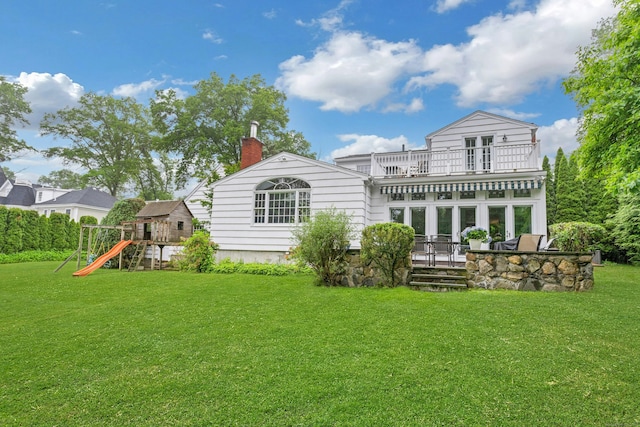 19 Orchard Ln, New Canaan, CT 06840 - back of property with a playground, a chimney, a yard, and a balcony