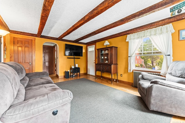 72 Westminster St, Hamden, CT 06518 - living area with arched walkways, beam ceiling, a textured ceiling, wood finished floors, and baseboards