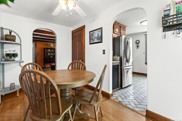72 Westminster St, Hamden, CT 06518 - dining space with arched walkways, a ceiling fan, baseboards, and light wood-style flooring