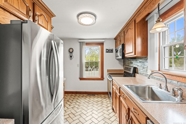 72 Westminster St, Hamden, CT 06518 - kitchen with appliances with stainless steel finishes, a sink, brown cabinetry, and plenty of natural light