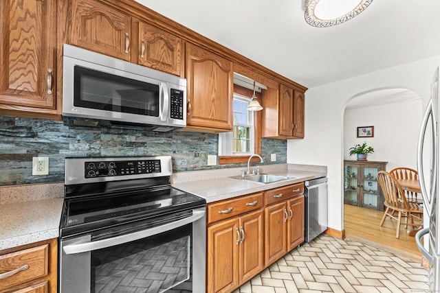 72 Westminster St, Hamden, CT 06518 - kitchen featuring stainless steel appliances, a sink, decorative backsplash, and light countertops