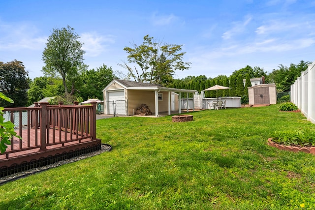 72 Westminster St, Hamden, CT 06518 - view of yard featuring a deck, a garage, and an outdoor fire pit