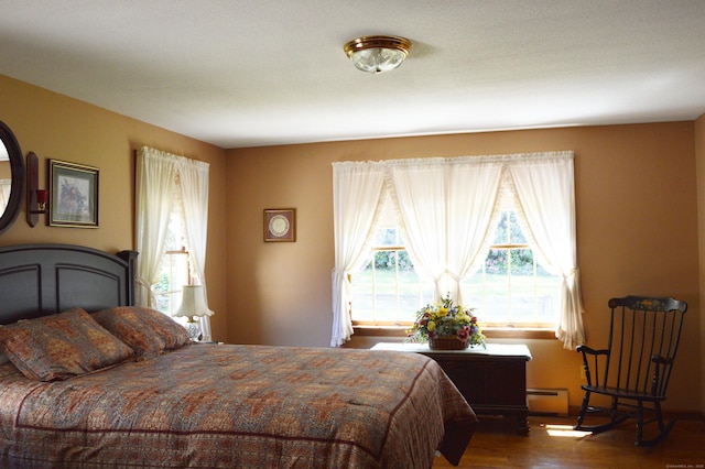 76 Country Ln, Bristol, CT 06010 - bedroom featuring baseboard heating and wood finished floors