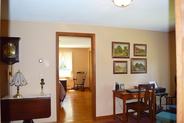 76 Country Ln, Bristol, CT 06010 - hallway featuring wood finished floors, a desk, and baseboards