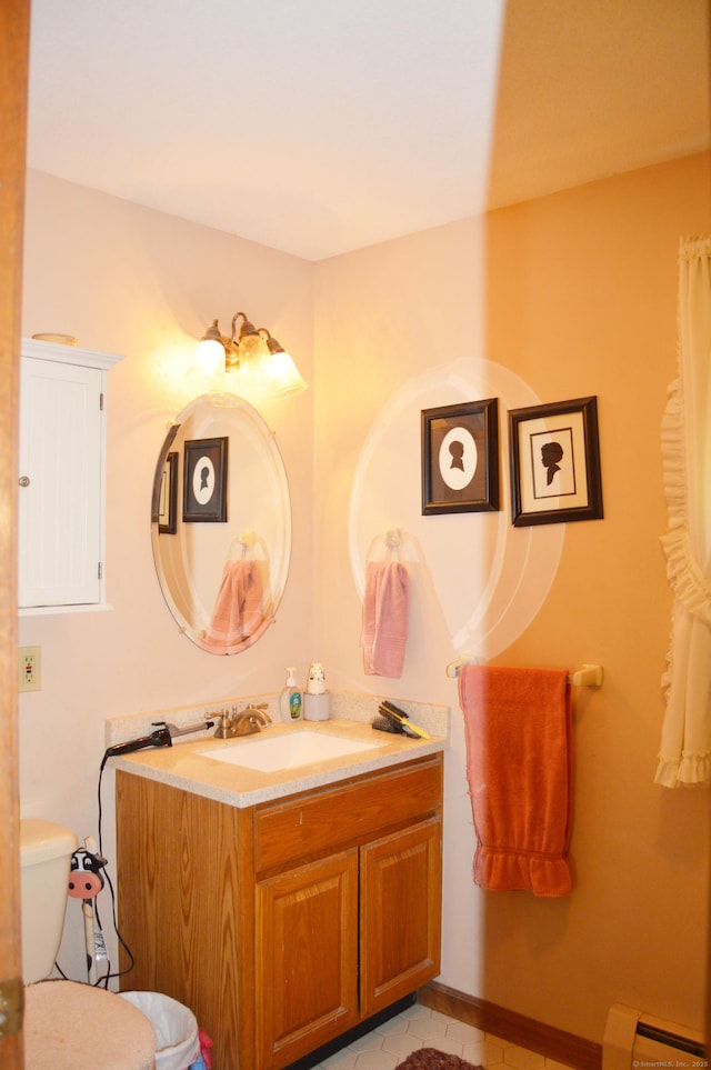 76 Country Ln, Bristol, CT 06010 - bathroom with vanity, a baseboard heating unit, toilet, and tile patterned floors