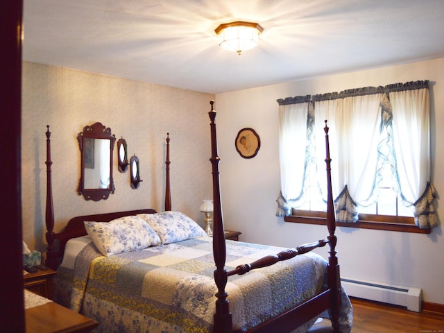 76 Country Ln, Bristol, CT 06010 - bedroom with a baseboard heating unit, baseboards, and wood finished floors