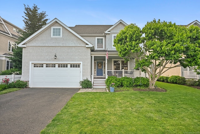view of front of house featuring a porch, asphalt driveway, and a garage