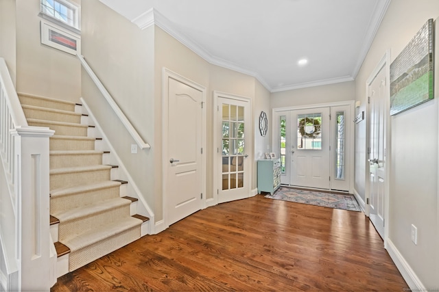 foyer entrance featuring wood finished floors, stairs, crown molding, recessed lighting, and baseboards