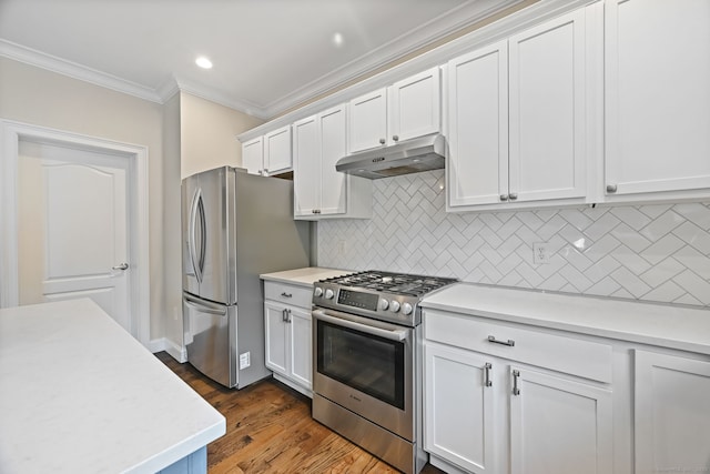 kitchen featuring under cabinet range hood, appliances with stainless steel finishes, ornamental molding, light countertops, and recessed lighting