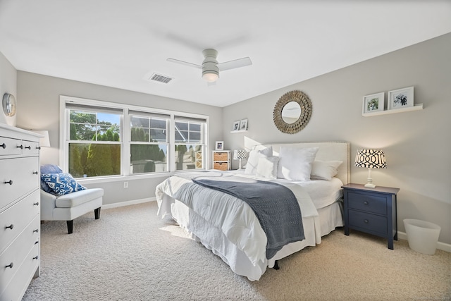 bedroom with light carpet, baseboards, and a ceiling fan