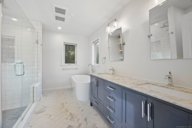 bathroom with a shower stall, marble look tiles, double vanity, a freestanding bath, and recessed lighting