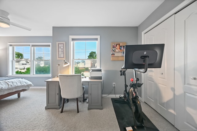 carpeted home office with plenty of natural light, baseboards, and a ceiling fan