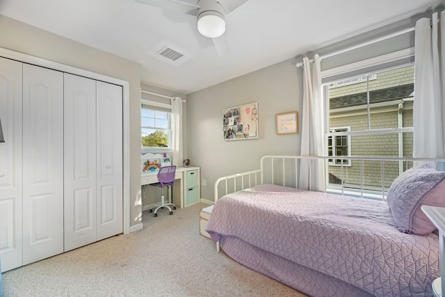 bedroom with a closet, carpet flooring, a ceiling fan, and baseboards