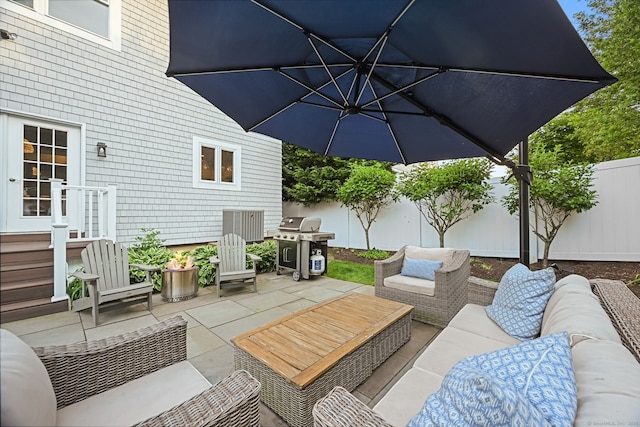 fenced backyard featuring an outdoor hangout area, a grill, and a patio area