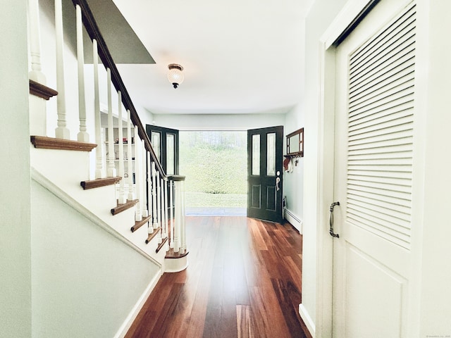 51 Boulder Brook Dr, Stamford, CT 06903 - entryway featuring a baseboard radiator, dark wood-style floors, baseboards, and stairs