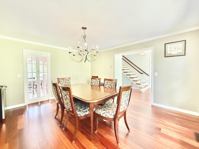 51 Boulder Brook Dr, Stamford, CT 06903 - dining space featuring light wood-type flooring, a chandelier, crown molding, baseboards, and stairway
