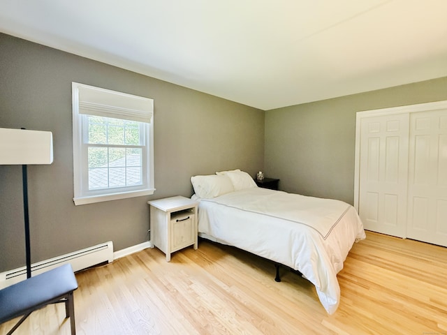 51 Boulder Brook Dr, Stamford, CT 06903 - bedroom featuring light wood-type flooring, a closet, baseboards, and baseboard heating