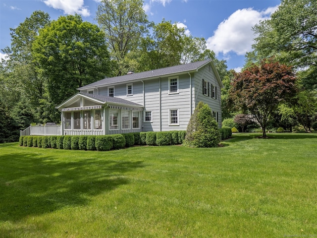 111 Washington Post Dr, Wilton, CT 06897 - back of property with a yard, a sunroom, and a shingled roof