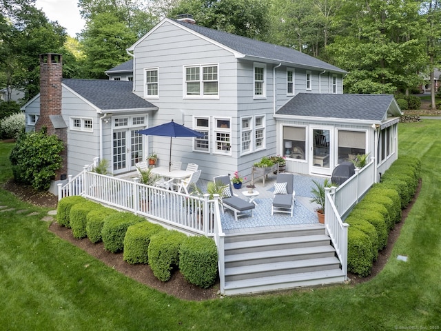 111 Washington Post Dr, Wilton, CT 06897 - back of house with a wooden deck, french doors, a sunroom, a lawn, and a shingled roof