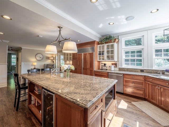 111 Washington Post Dr, Wilton, CT 06897 - kitchen with stainless steel appliances, beverage cooler, crown molding, wood finished floors, and a kitchen island with sink