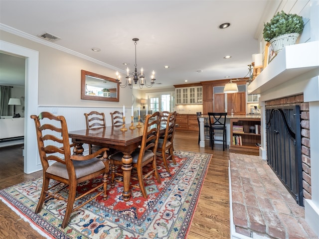 111 Washington Post Dr, Wilton, CT 06897 - dining room with a wainscoted wall, ornamental molding, a chandelier, a fireplace, and recessed lighting