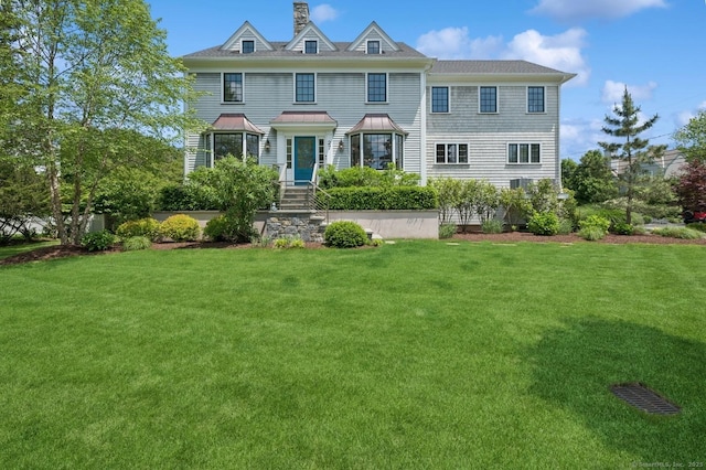 27 Waverly Rd, Darien, CT 06820 - view of front facade featuring a front yard, a chimney, and a standing seam roof