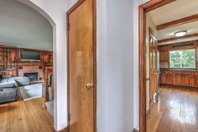 202 Mountain Rd, Cheshire, CT 06410 - hall with light wood finished floors, arched walkways, and a sink
