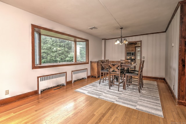 202 Mountain Rd, Cheshire, CT 06410 - dining space featuring radiator heating unit, a chandelier, hardwood / wood-style flooring, and baseboards