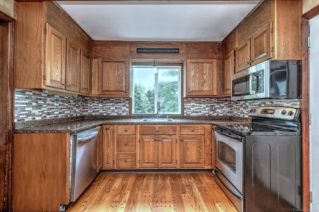 202 Mountain Rd, Cheshire, CT 06410 - kitchen featuring stainless steel appliances, dark countertops, brown cabinetry, and light wood finished floors
