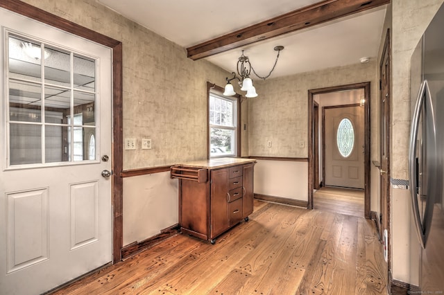 202 Mountain Rd, Cheshire, CT 06410 - entryway with a chandelier, light wood-style floors, beam ceiling, and baseboards