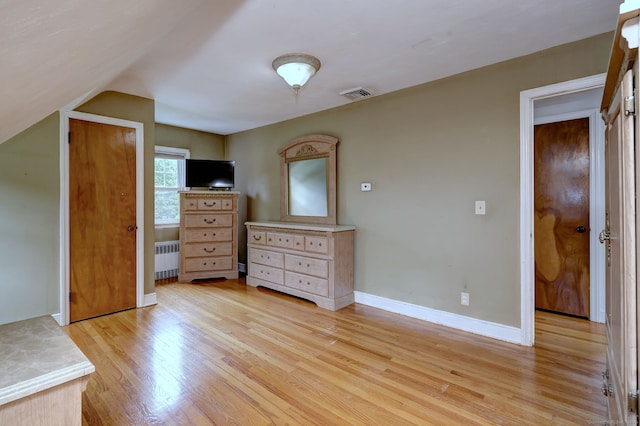 202 Mountain Rd, Cheshire, CT 06410 - bedroom with radiator heating unit, light wood-style floors, and baseboards