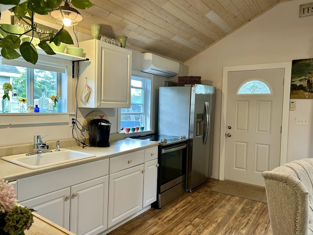 28 1st St, Madison, CT 06443 - kitchen featuring appliances with stainless steel finishes, a wall mounted AC, wood finished floors, healthy amount of natural light, and vaulted ceiling