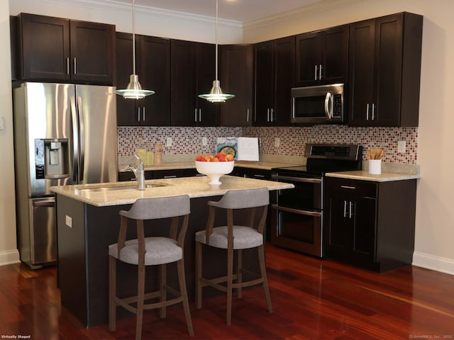 144 E Ave Apt B106, Norwalk, CT 06851 - kitchen with appliances with stainless steel finishes, a sink, baseboards, dark wood finished floors, and decorative light fixtures